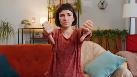 woman showing thumbs down sign gesture expressing discontent disapproval dissatisfied dislike