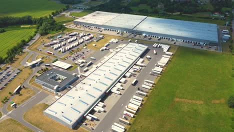 Aerial-view-of-warehouse-storages-or-industrial-factory-or-logistics-center-from-above