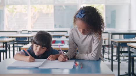 Focused-Black-and-Latin-primary-school-pupil-girls-drawing