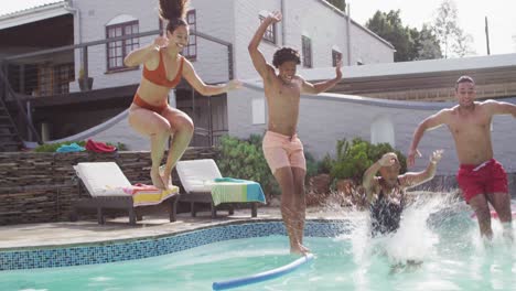 group of happy diverse female and male friends jumping into swimming pool at pool party