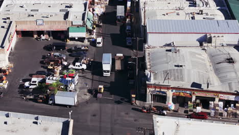 aerial view of a bustling commercial district with trucks and warehouses