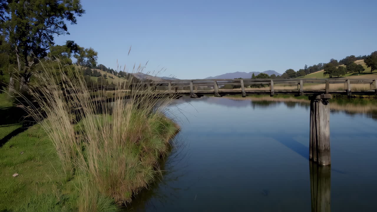 Scenic River Landscape with Wooden Bridge and Hills