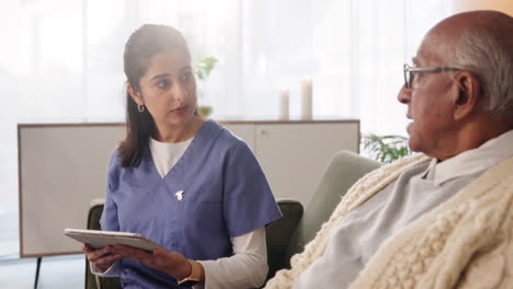 nurse assisting senior patient with digital tablet