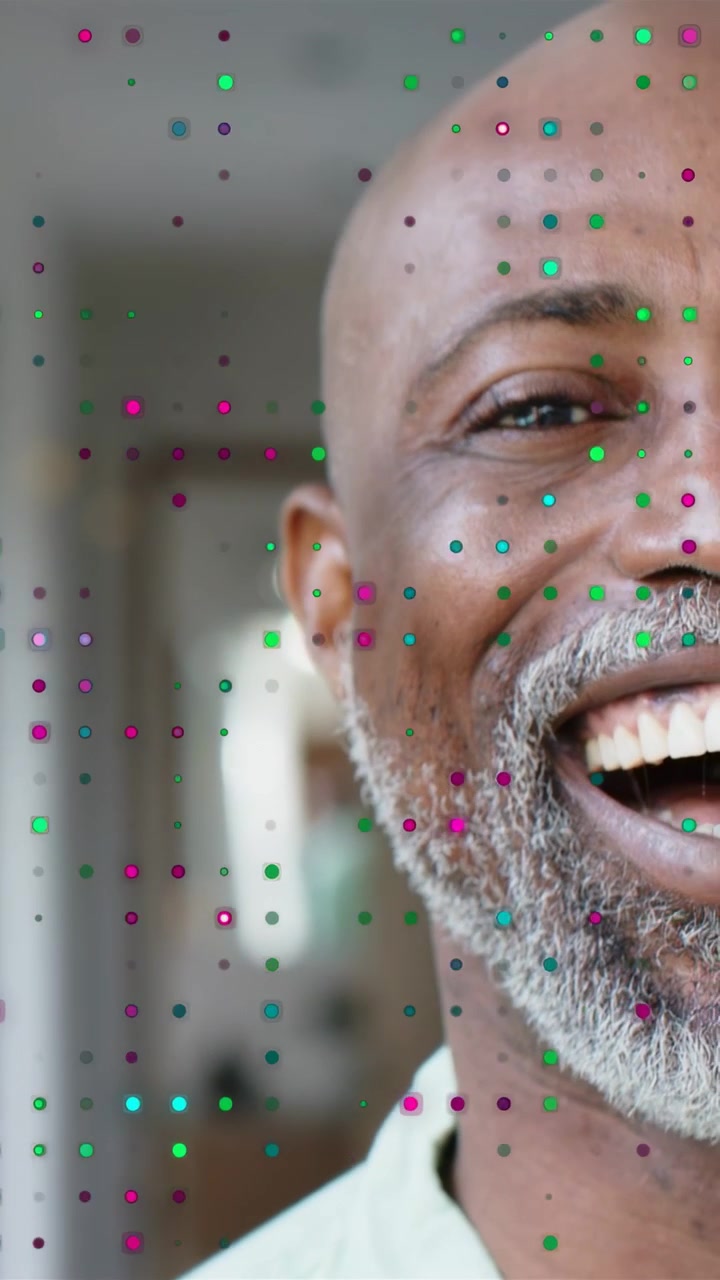 Vertical video: Mature man reacting to camera shift with dot overlay, smiling then laughing in ad