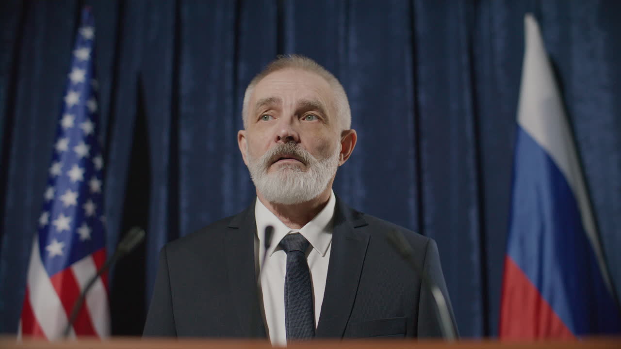 Senior Male Diplomat Giving Public Speech at Global Press Conference