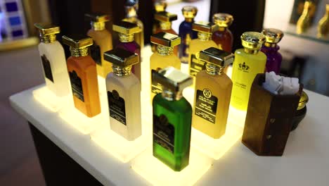 a variety of perfumes showcased on a lit table