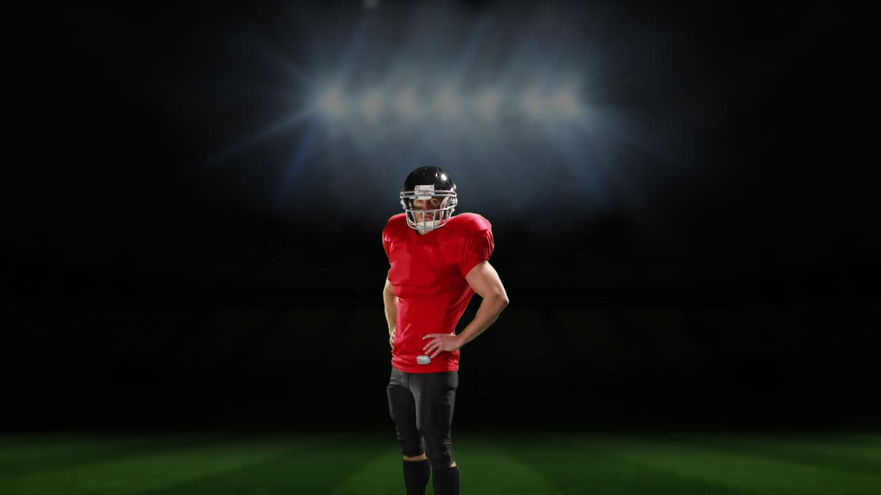 스포츠 경기장 앞에 서 있는 프로 미식축구 선수