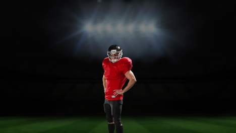 professional american football player standing in front of a sports stadium