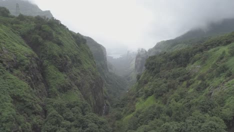 A-cinematic-aerial-drone-view-of-a-lush-green-rain-forest-on-the-hills-of-western-ghats-in-Andharban-forest-of-Pimpir-region-in-Maharashtra,-a-popular-trekking-destination-for-local-tourists