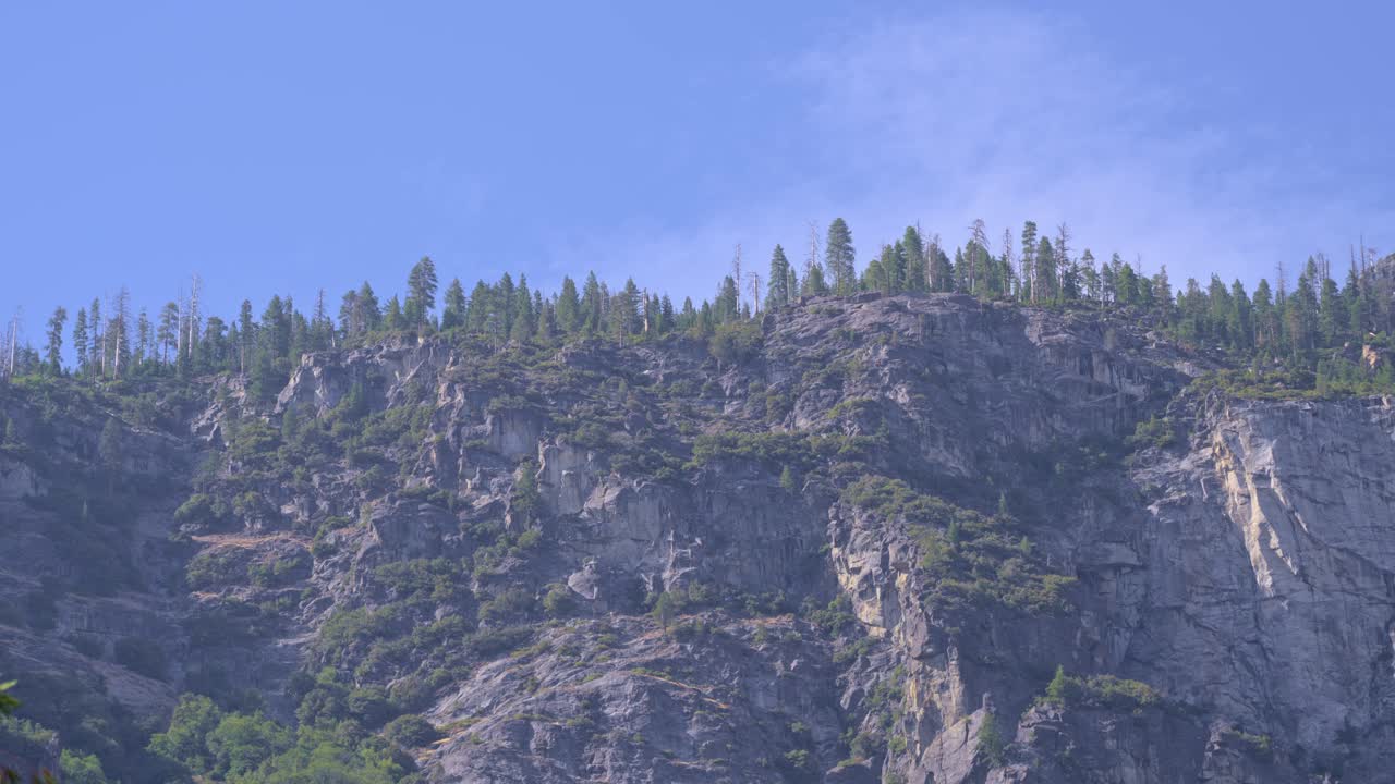 4K panoramic footage glides across Yosemite’s massive granite outcrops—weather-polished domes and sheer cliff faces created from tough, slow-cooled magma now exposed by erosion