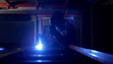 metalsmith using welding torch in workshop 4k