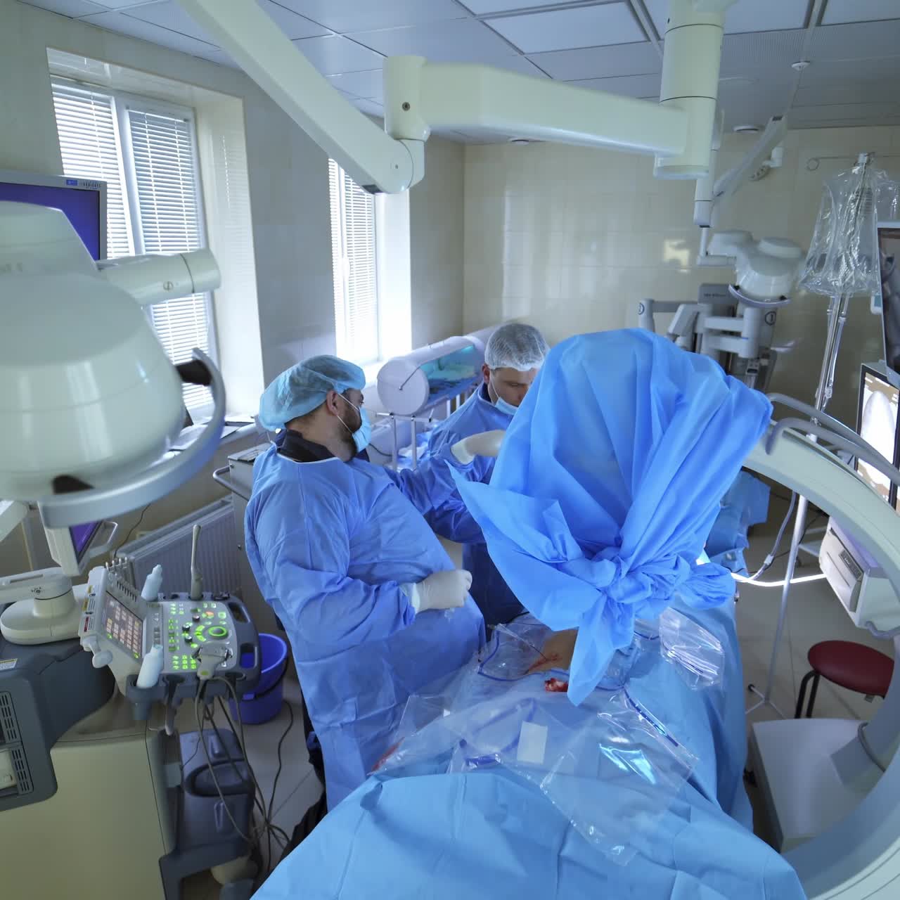Operation room with specialists. Teamwork of surgeons performing operation on the background of modern equipment in private clinic