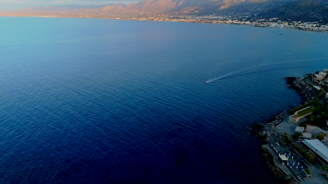 Aerial - pleasure boat near Chersonissos coastline in Crete Greece