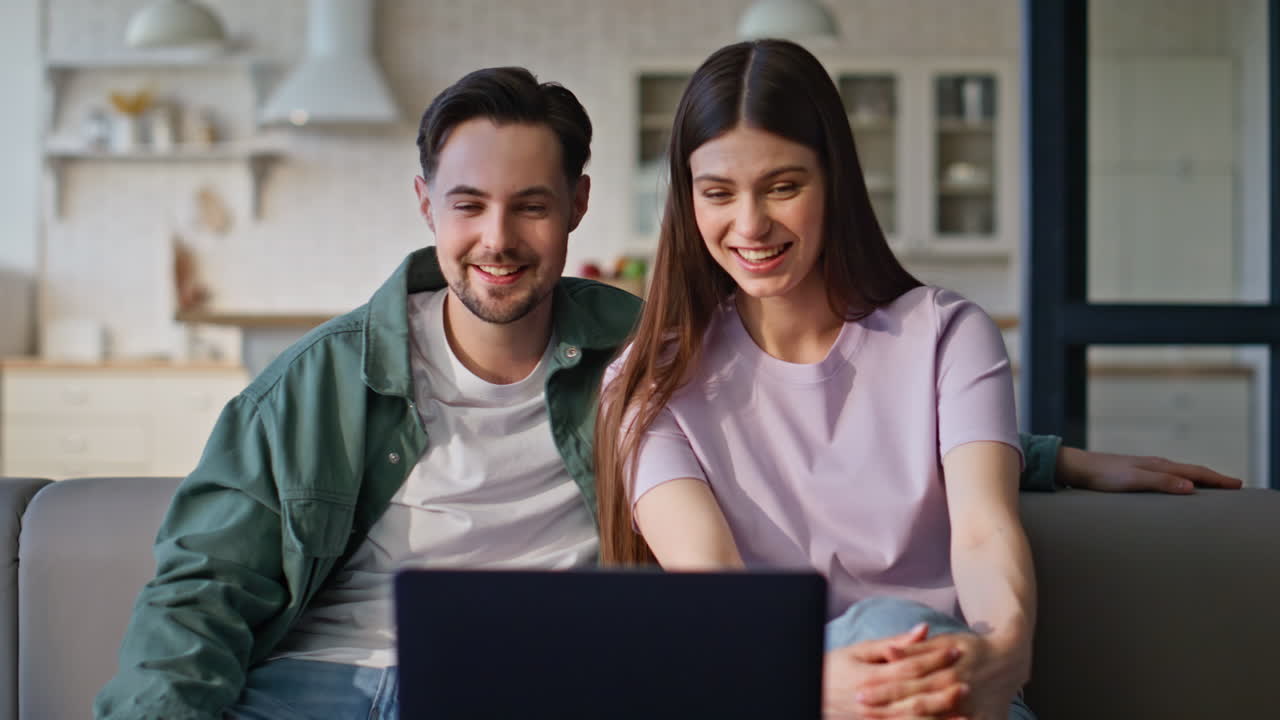 Soulmates video calling laptop relaxing on cozy couch closeup. Spouses talking