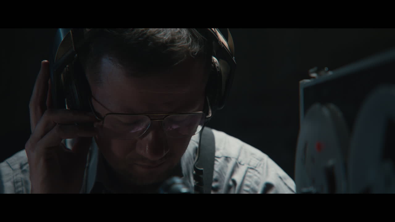 An intelligence officer listens to the wiretap recordings