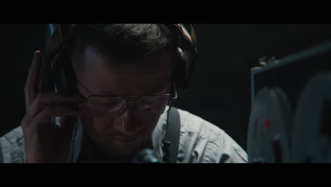 an intelligence officer listens to the wiretap recordings