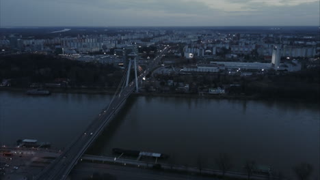 Slow-Descending-Wide-Aerial-shot-of-SNP-Bridge-and-Petrzalka-in-Bratislava-at-twilight