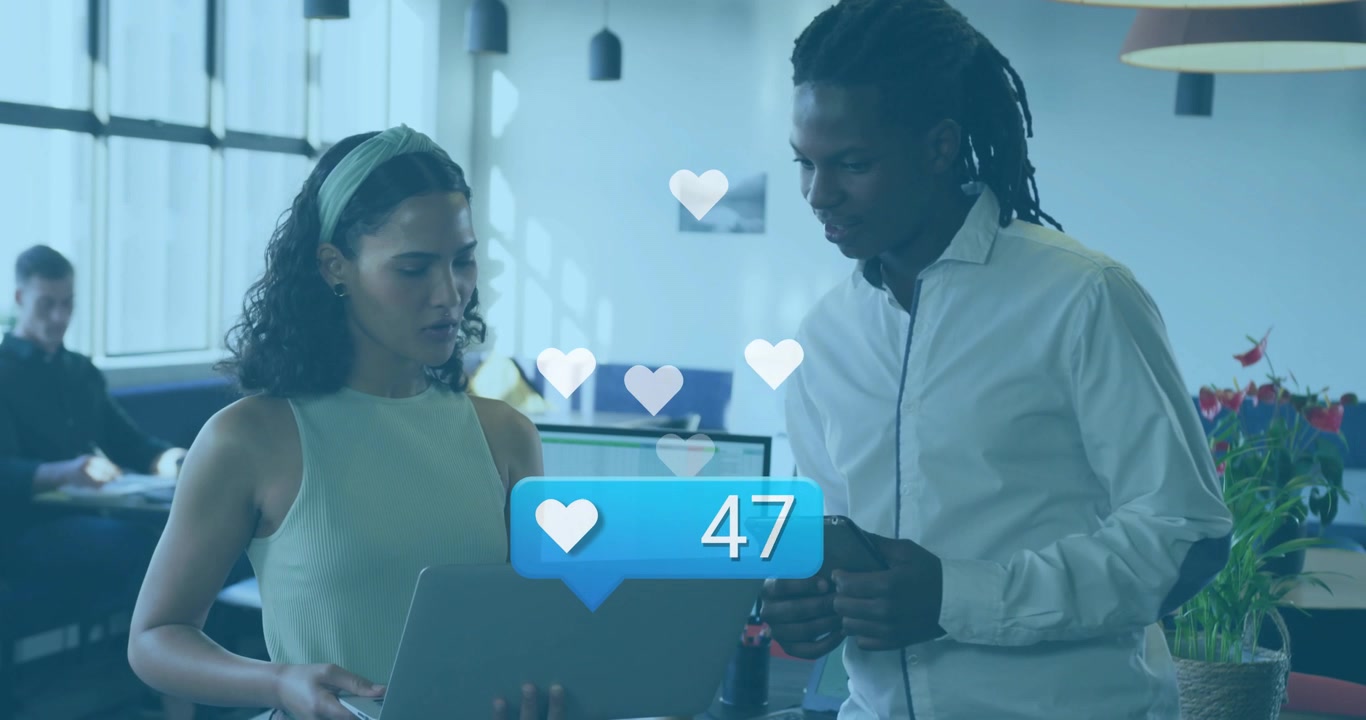 Woman showing laptop, man watching, animated likes rising on screen, confetti marking marketing win
