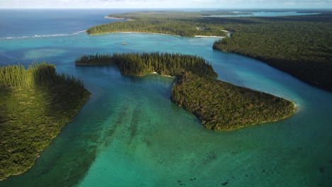 gradual aerial rise over small uninhabited island in oro bay, isle of pines