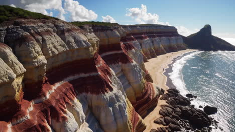vibrant layered cliffs overlooking a serene beach