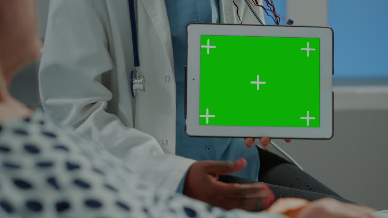 African american doctor showing tablet with green screen
