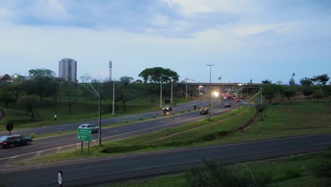 Bauru-daily-local-road-car-traffic-in-a-cloudy-day-at-dusk-time