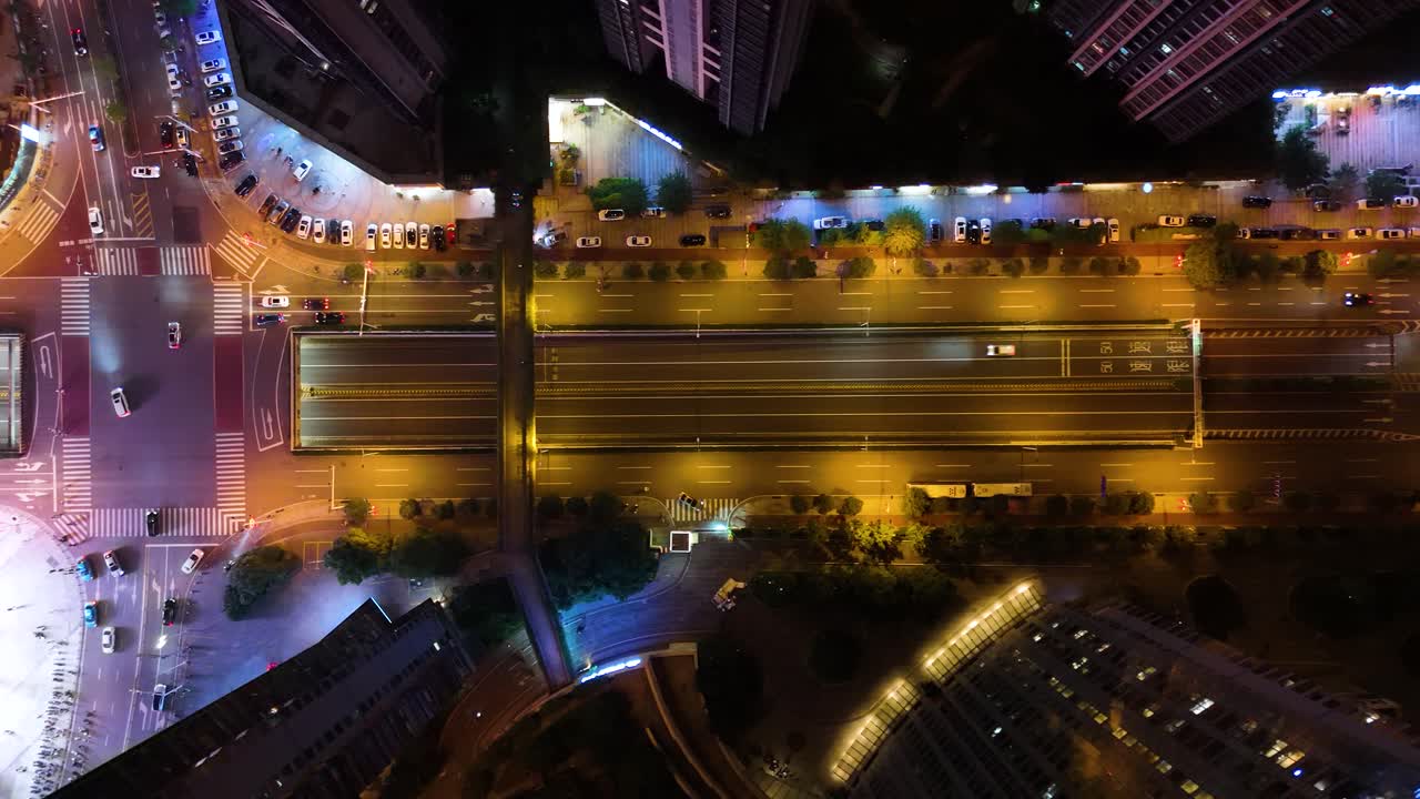 Aerial shot overhead a congested street crossing in downtown Changsha at night, China