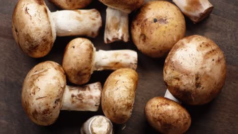 close-up of fresh cremini mushrooms on a wooden cutting board