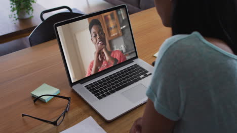 african american woman having a video call with female colleague on laptop