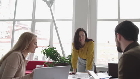 Females-in-a-business-meeting.-Teamwork-discussing-with-a-male-coworker.-International-Women's-Day.