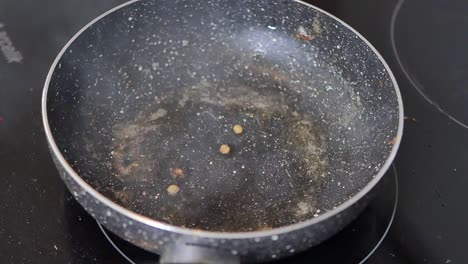 dirty empty frying pan on stovetop