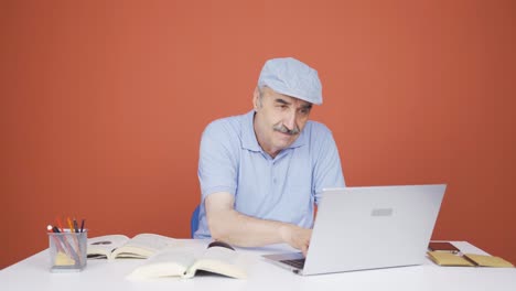 Concentrated-old-man-working-on-laptop.