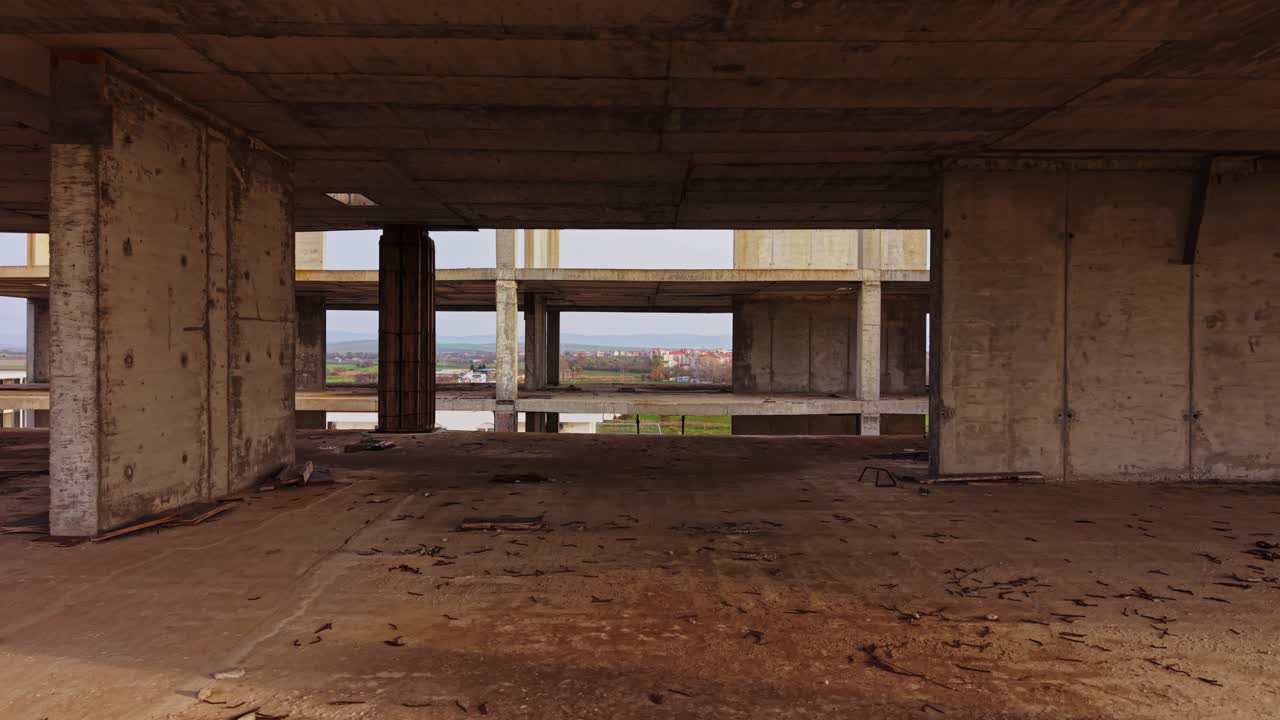 View of unfinished building with open structure in rural landscape
