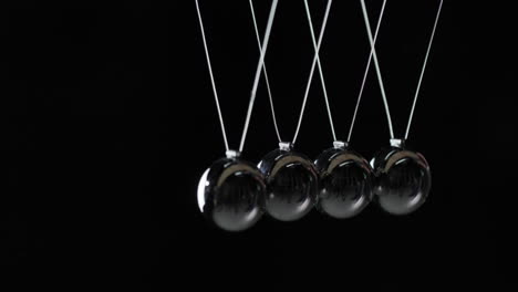 balls in newton's cradle hit each other demonstrating energy conservation law 1