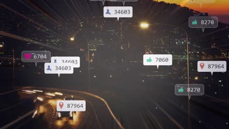 Animation-of-social-media-notifications-over-fast-motion-traffic-on-road-and-city-lights-at-sunset