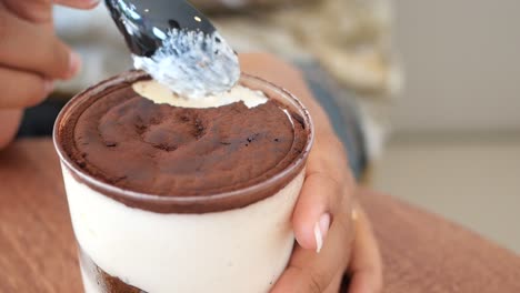 woman eating delicious tiramisu dessert