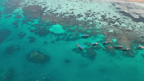 traditional boats floating on the coral reefs of zanzibar