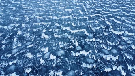 textured surface of frozen terrain with glaciers