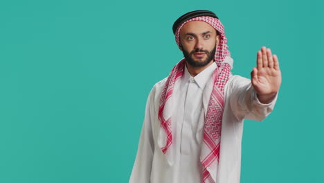 model doing stop symbol with palm