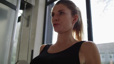 Handheld-view-of-sporty-woman-working-out-at-the-gym