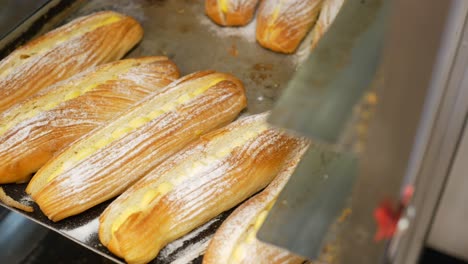 freshly baked cream filled breads on a tray