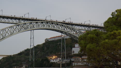 people on dom luis i bridge in porto, portugal. wide shot