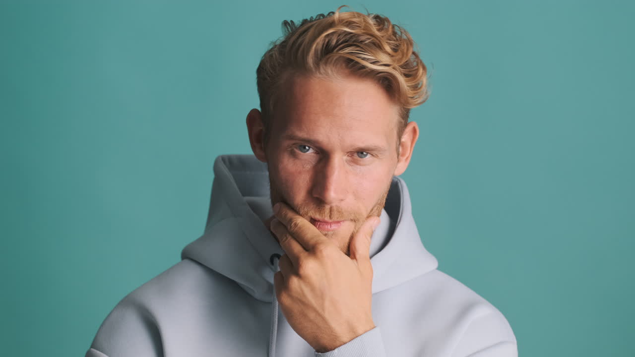 매력적인 남자가 미소 짓고, 유혹하고, 포즈를 취하고