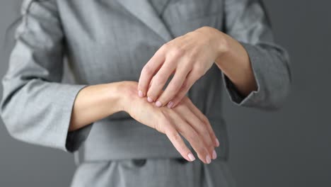 person scratching an itchy rash on their hand