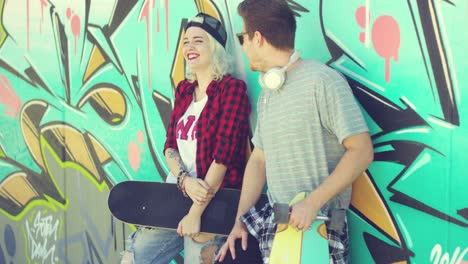 trendy modern urban couple chatting at skate park