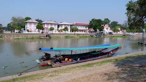 a long boat travels along a river