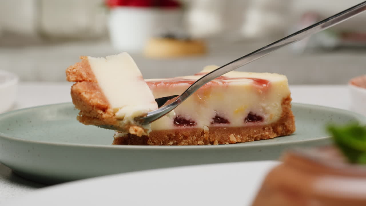 A slice of cheesecake with a spoon