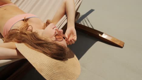 High-angle-view-of-Caucasian-woman-relaxing-in-a-hammock-at-beach-4k