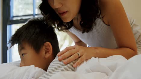 mother waking up her son in bedroom 4k