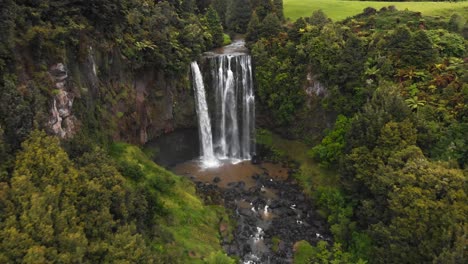 a remote unknown waterfall with colorful valleys and colorful lakes in new zealand